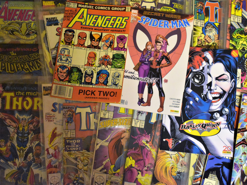 A variety of comic books on a table
