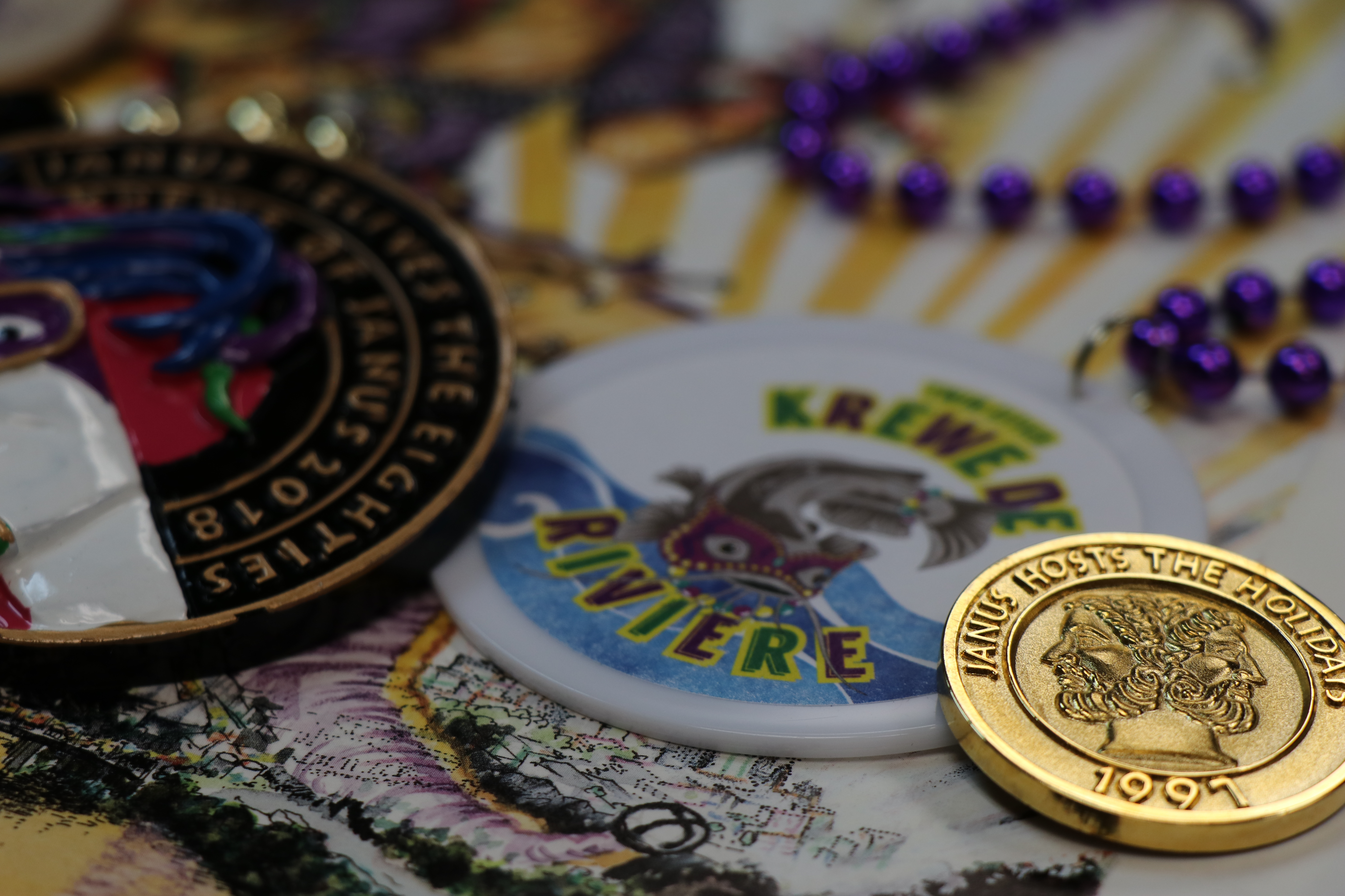 Mardi Gras doubloons and beads are arranged artfully on a table.