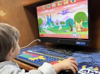 child at early literacy computer