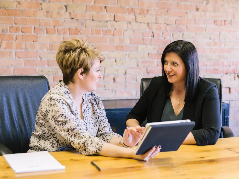 women at a conference table