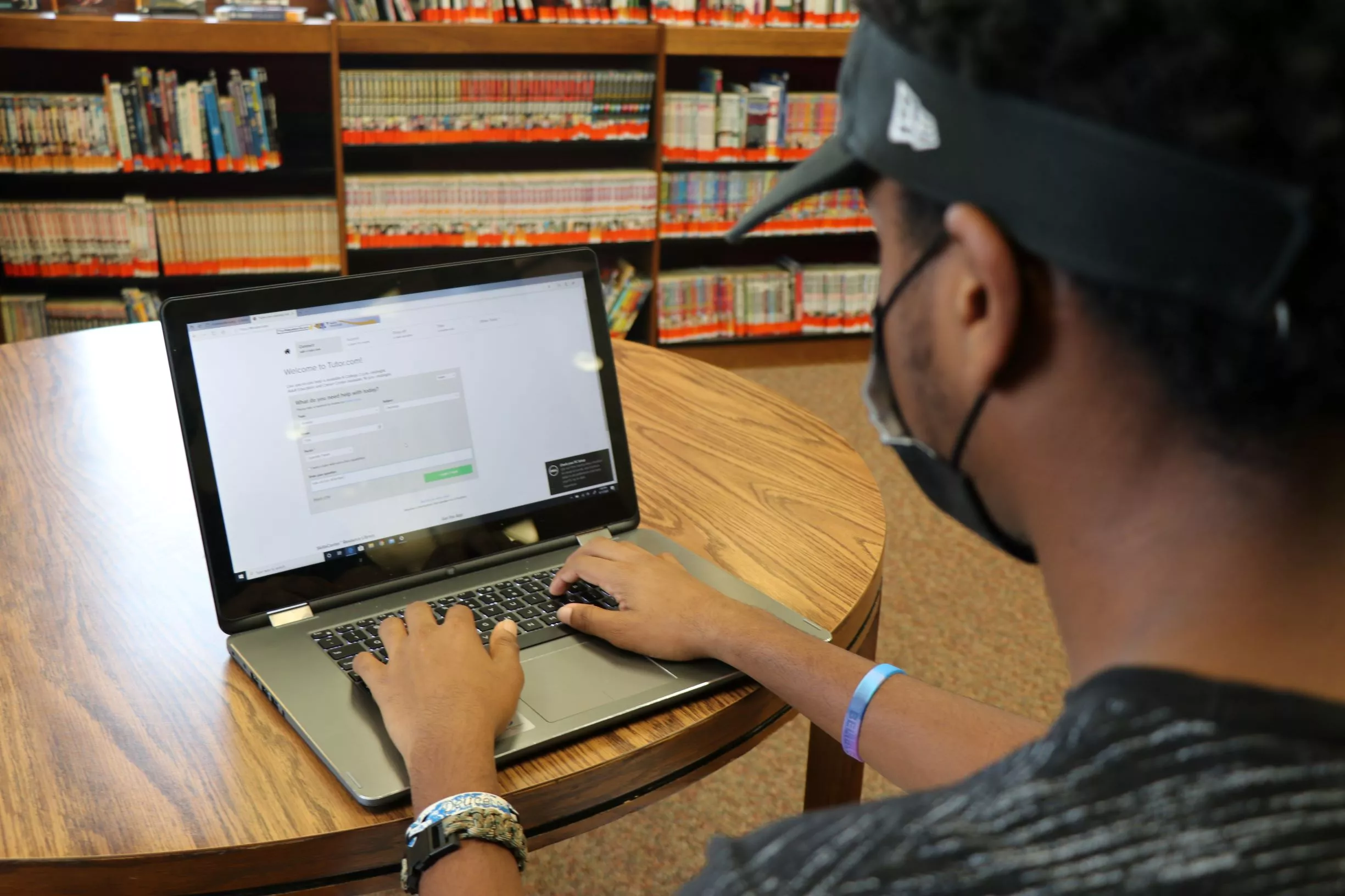 teenage boy working on his laptop