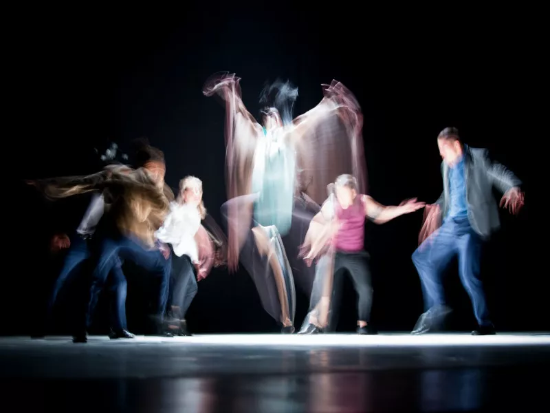 The Dyptik dance troupe performs on a stage in Ramallah, their bodies blurred in motion