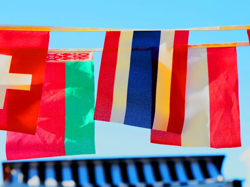 An assortment of national flags hanging above a courtyard